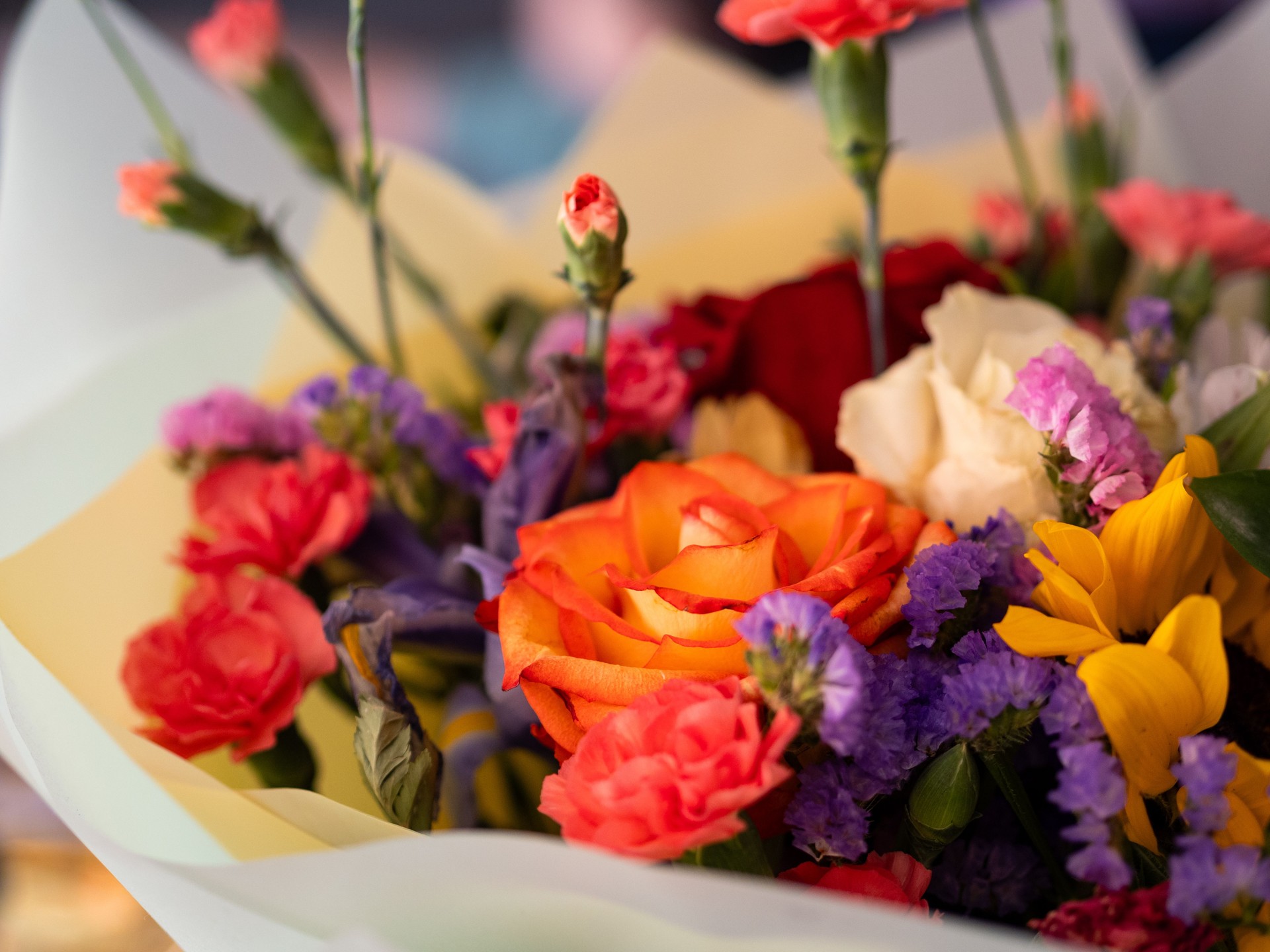 Colorful bouquet filled with roses and mixed flowers on display in a vibrant setting